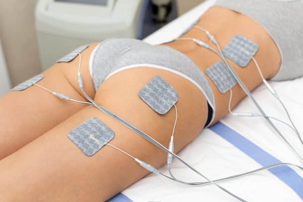 Beautiful woman getting electrostimulation therapy, anti-cellulite and anti-fat therapy